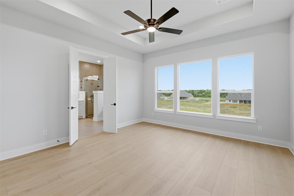 809 Vly Rdg Road Van Alstyne, TX 75495 - Photo 12 of 30 an empty room with windows and a ceiling fan