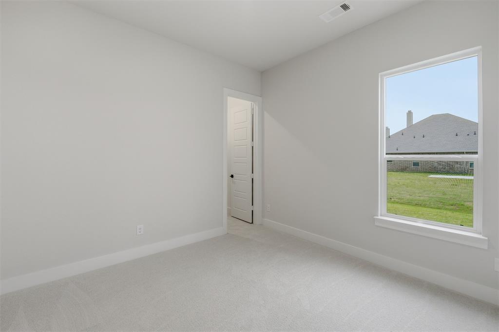 809 Vly Rdg Road Van Alstyne, TX 75495 - Photo 16 of 30 an empty room with a window and a dresser