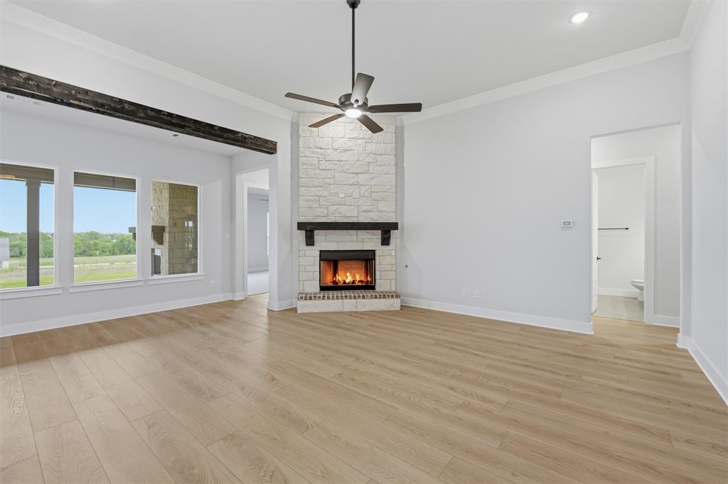 809 Vly Rdg Road Van Alstyne, TX 75495 - Photo 20 of 30 a view of an empty room with wooden floor fireplace and a window