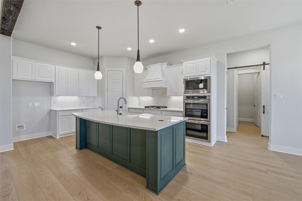 809 Vly Rdg Road Van Alstyne, TX 75495 - Photo 22 of 30 a kitchen with kitchen island a sink stainless steel appliances and cabinets