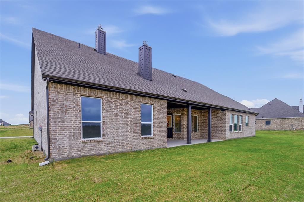 809 Vly Rdg Road Van Alstyne, TX 75495 - Photo 25 of 30 a front view of a house with garden