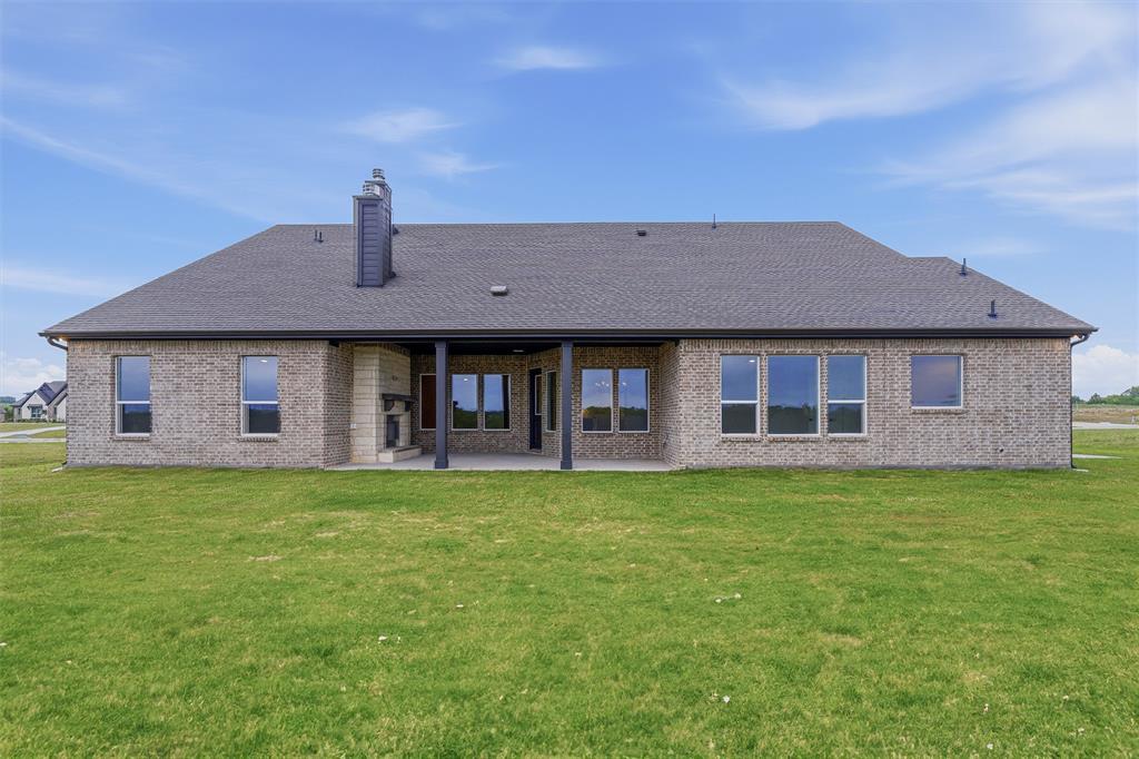 809 Vly Rdg Road Van Alstyne, TX 75495 - Photo 26 of 30 a front view of a house with a garden