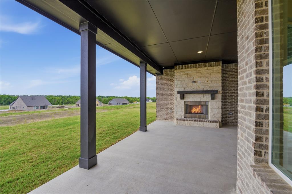 809 Vly Rdg Road Van Alstyne, TX 75495 - Photo 28 of 30 a view of an empty room with a floor to ceiling window and a fireplace