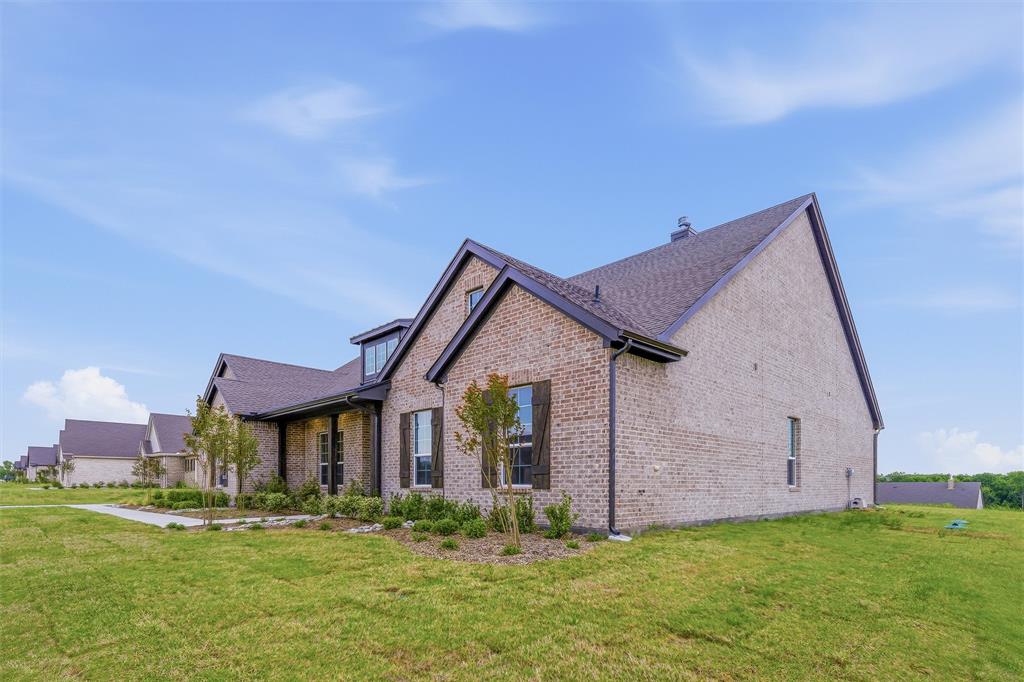 809 Vly Rdg Road Van Alstyne, TX 75495 - Photo 4 of 30 a front view of a house with a garden