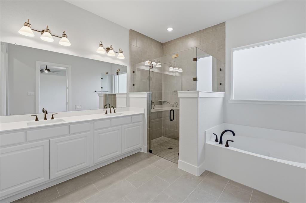 809 Vly Rdg Road Van Alstyne, TX 75495 - Photo 9 of 30 a bathroom with a tub sink double and mirror