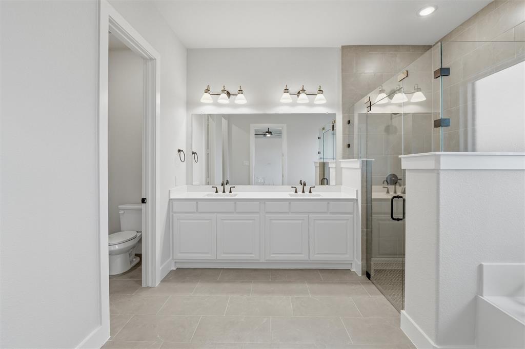 809 Vly Rdg Road Van Alstyne, TX 75495 - Photo 10 of 30 a bathroom with a double vanity sink mirror and shower