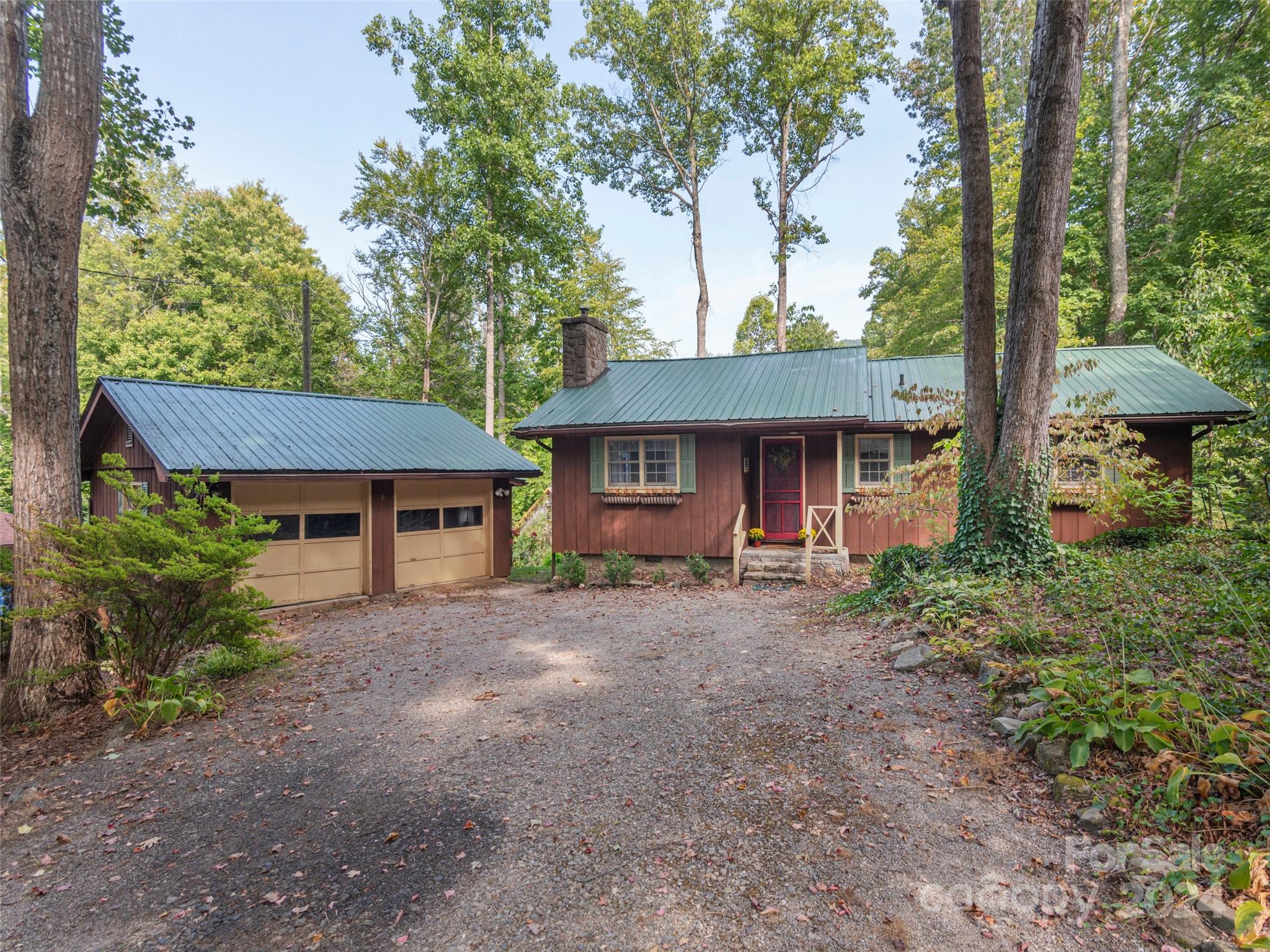 183 Reuben Branch Road Maggie Valley, NC 28751 - Photo 1 of 29 a front view of a house with garden