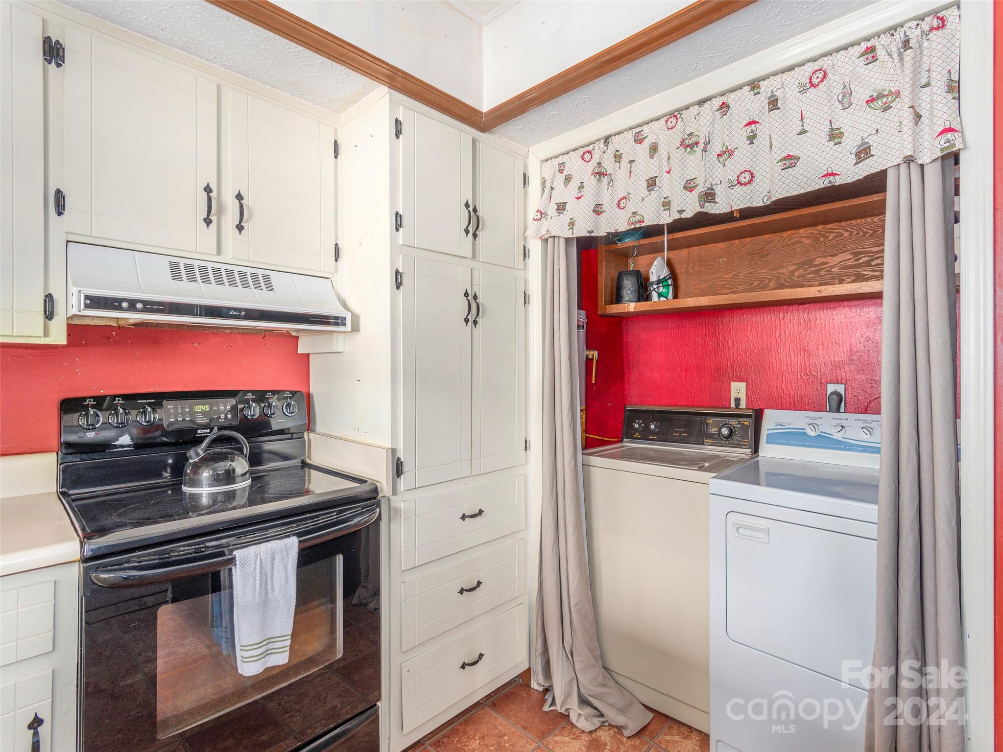 183 Reuben Branch Road Maggie Valley, NC 28751 - Photo 11 of 29 a kitchen with stainless steel appliances a stove and a refrigerator