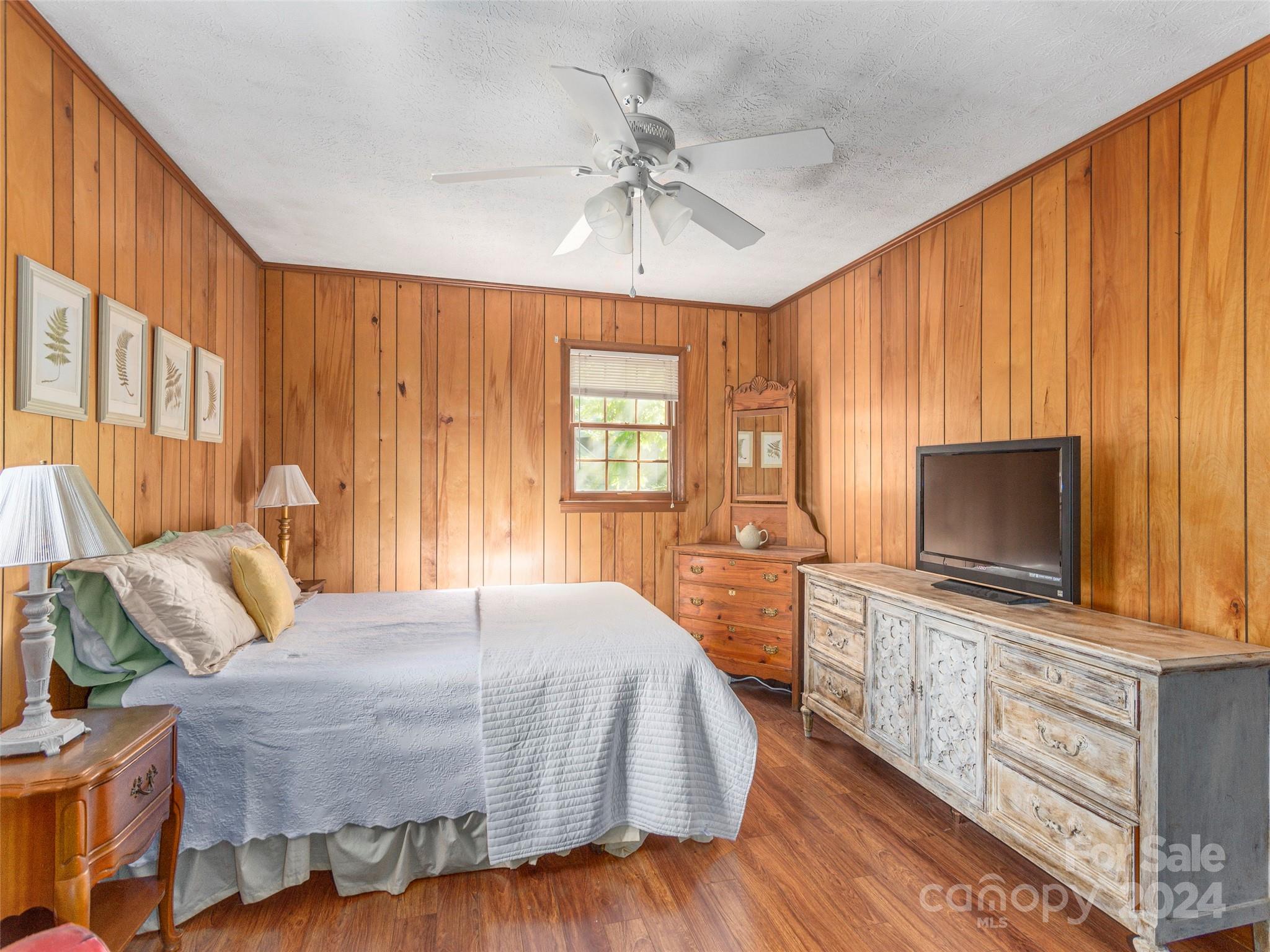 183 Reuben Branch Road Maggie Valley, NC 28751 - Photo 13 of 29 a bedroom with a bed and a flat screen tv