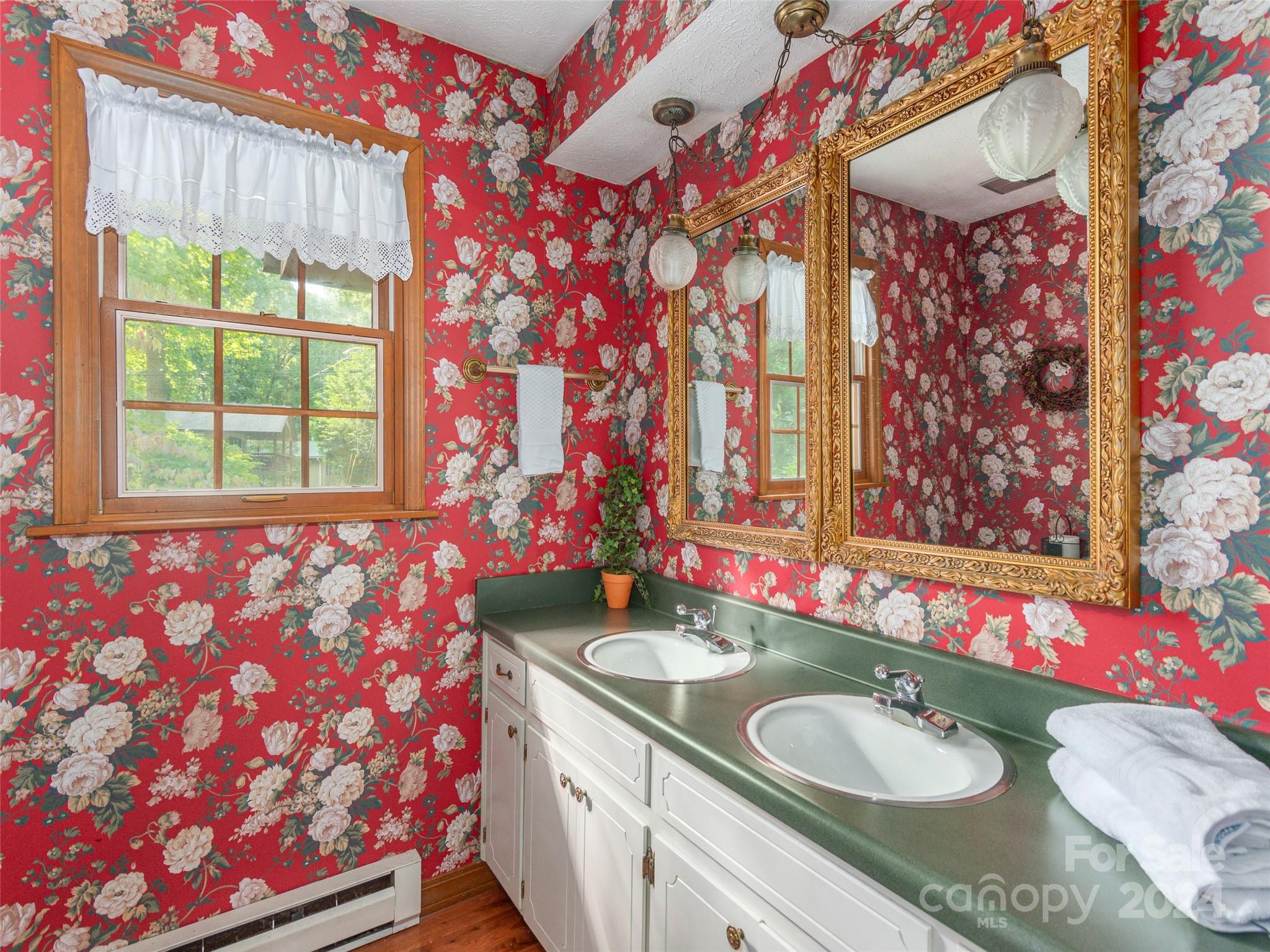 183 Reuben Branch Road Maggie Valley, NC 28751 - Photo 16 of 29 a bathroom with a sink vanity mirror and a bathtub