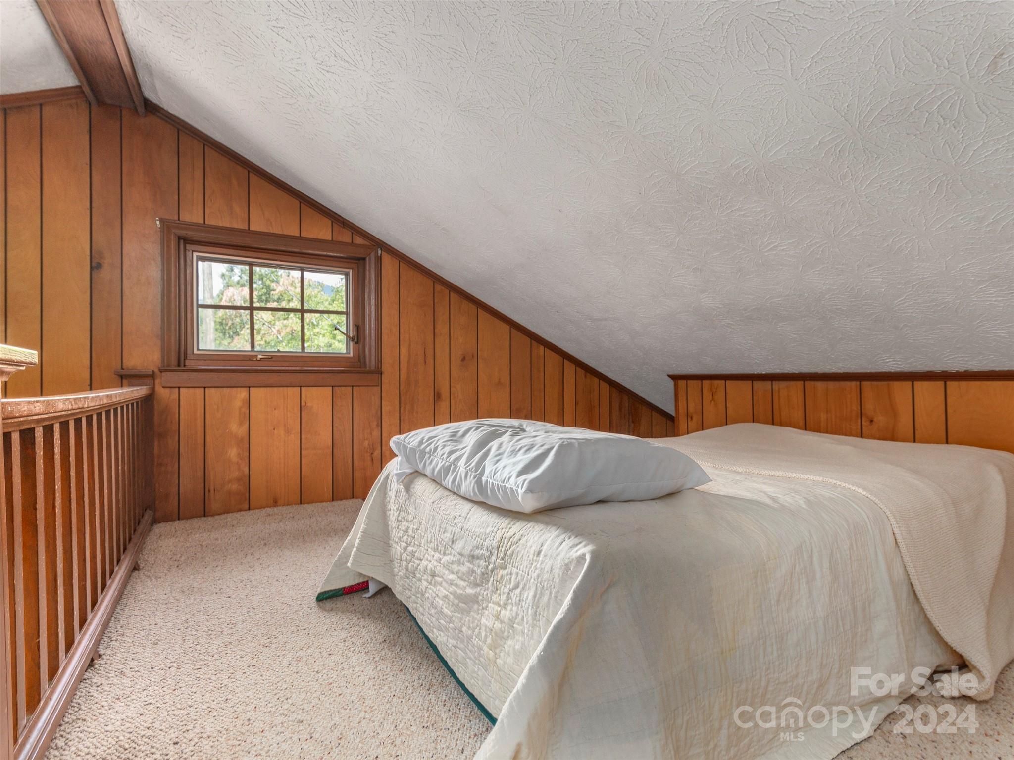 183 Reuben Branch Road Maggie Valley, NC 28751 - Photo 17 of 29 a bed sitting in a bedroom next to a window