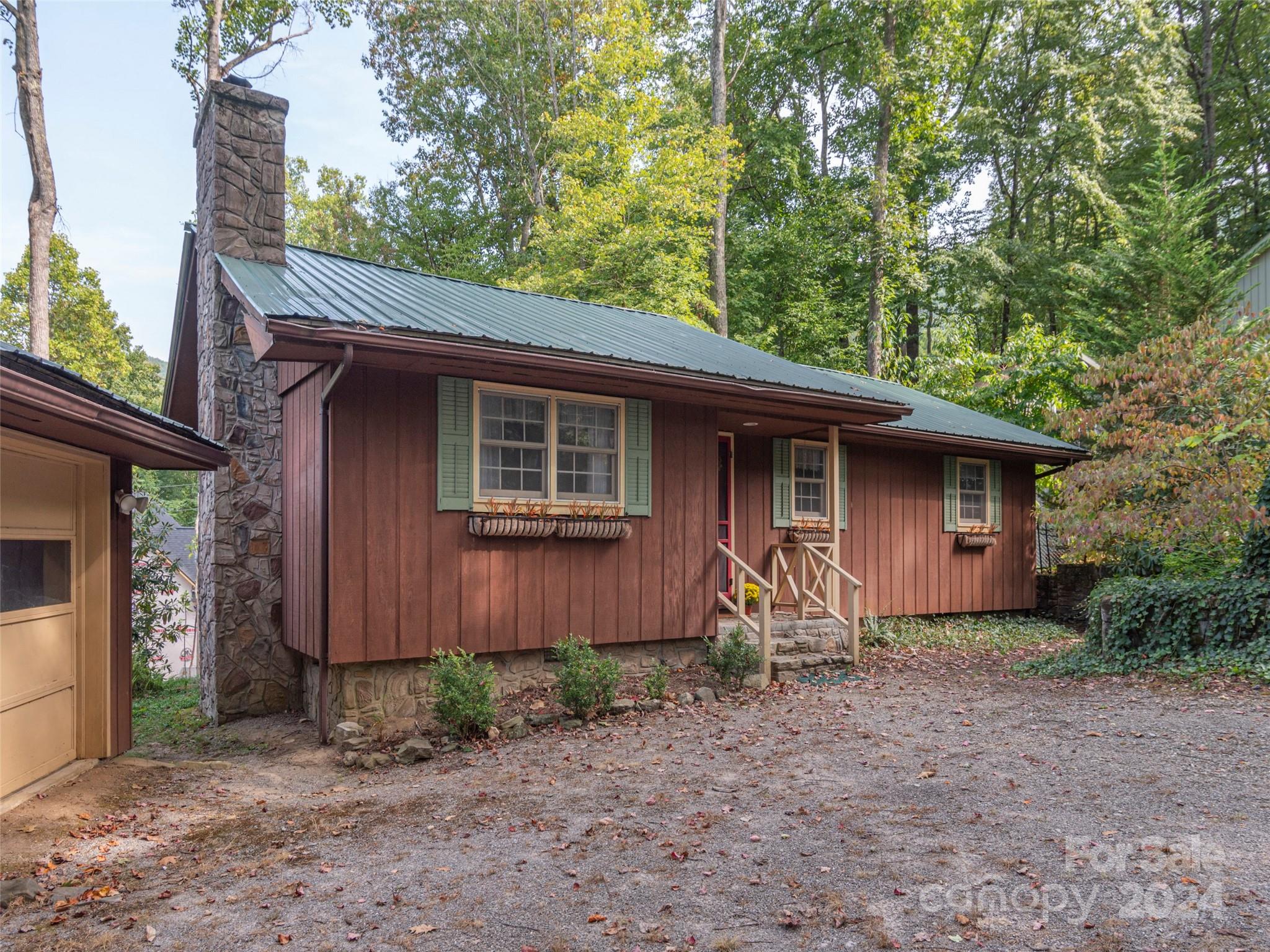 183 Reuben Branch Road Maggie Valley, NC 28751 - Photo 2 of 29 a front view of a house with garden