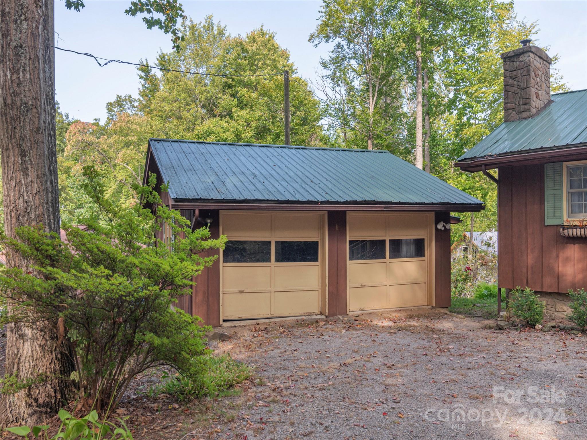 183 Reuben Branch Road Maggie Valley, NC 28751 - Photo 26 of 29 a view of a white house with a yard and large tree