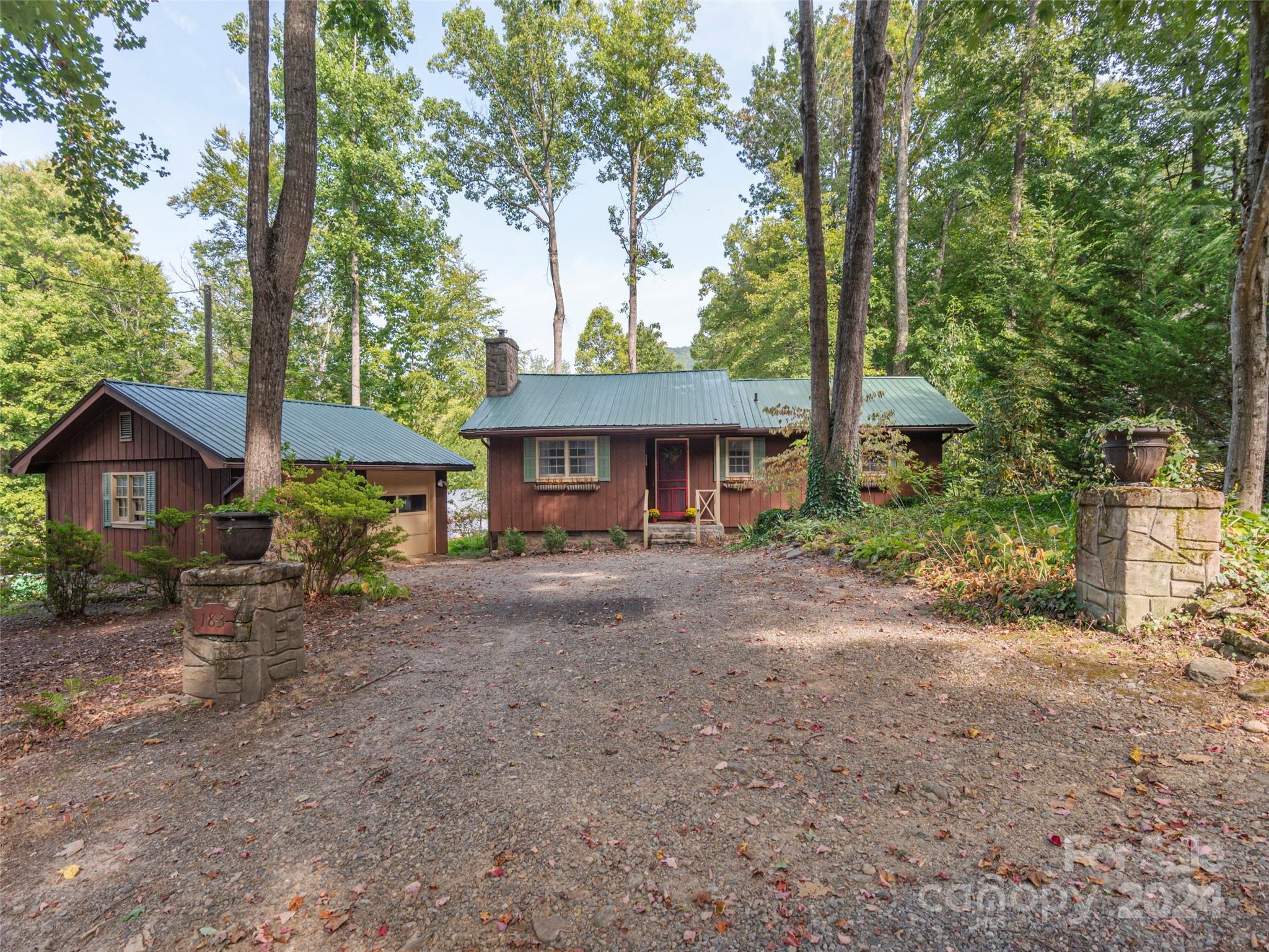 183 Reuben Branch Road Maggie Valley, NC 28751 - Photo 29 of 29 a front view of a house with garden