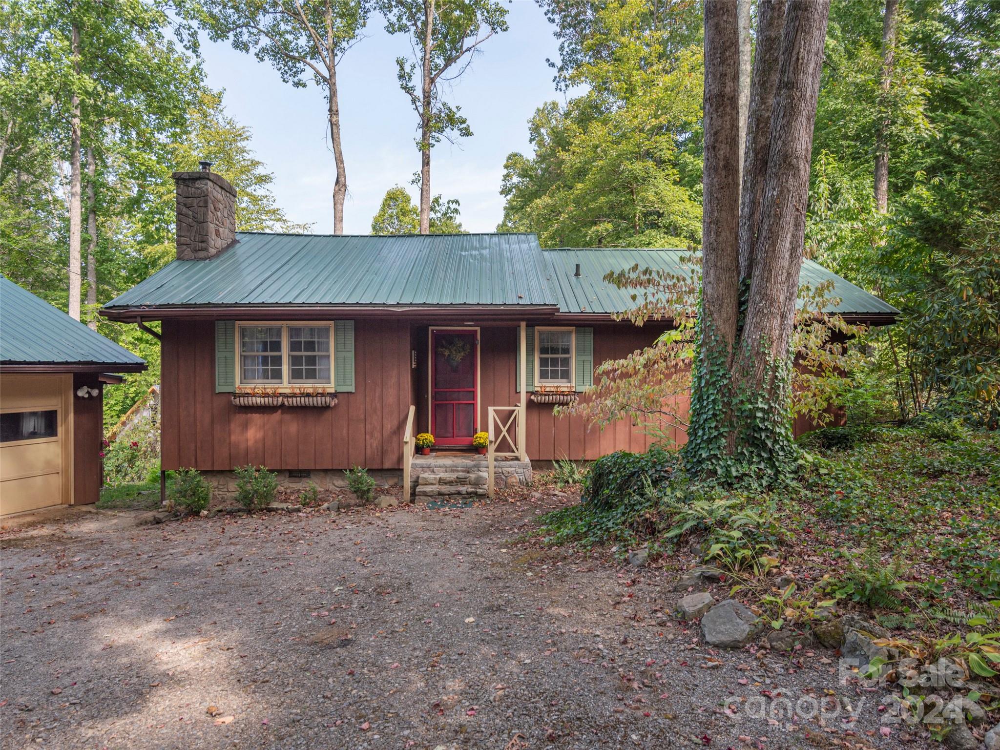 183 Reuben Branch Road Maggie Valley, NC 28751 - Photo 3 of 29 a front view of a house with garden