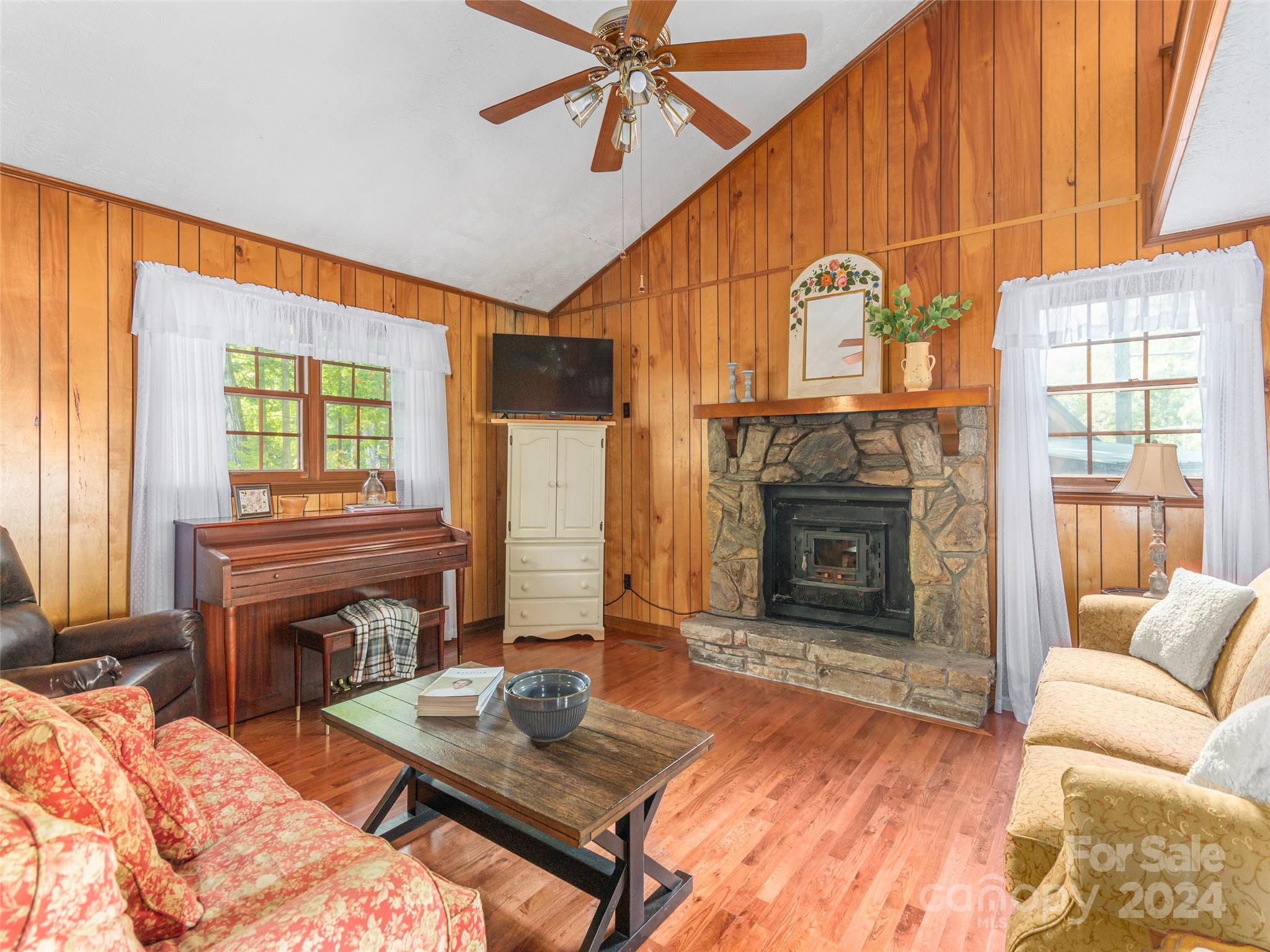 183 Reuben Branch Road Maggie Valley, NC 28751 - Photo 5 of 29 a living room with furniture a fireplace and a window