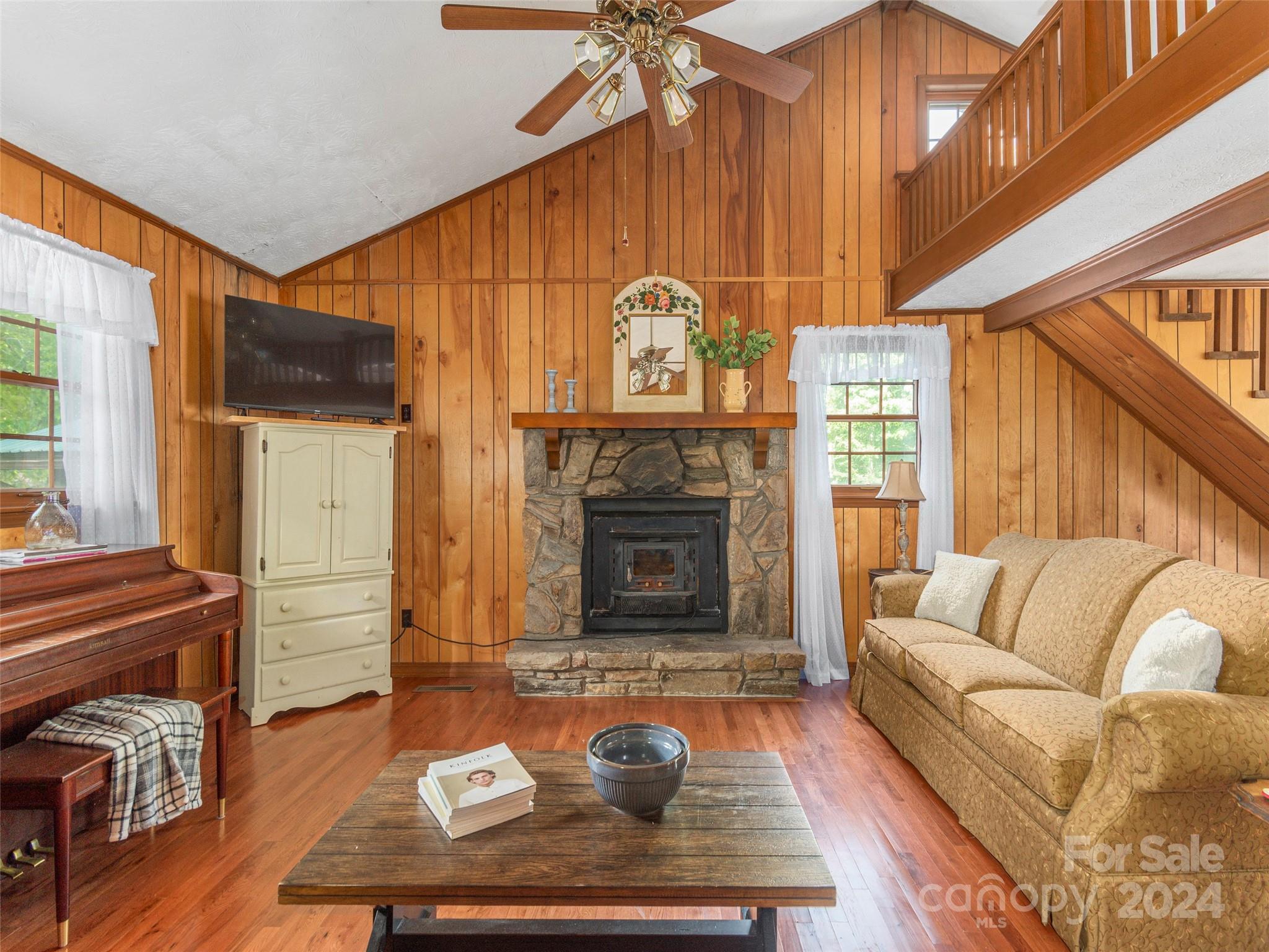 183 Reuben Branch Road Maggie Valley, NC 28751 - Photo 6 of 29 a living room with furniture a fireplace and wooden floor
