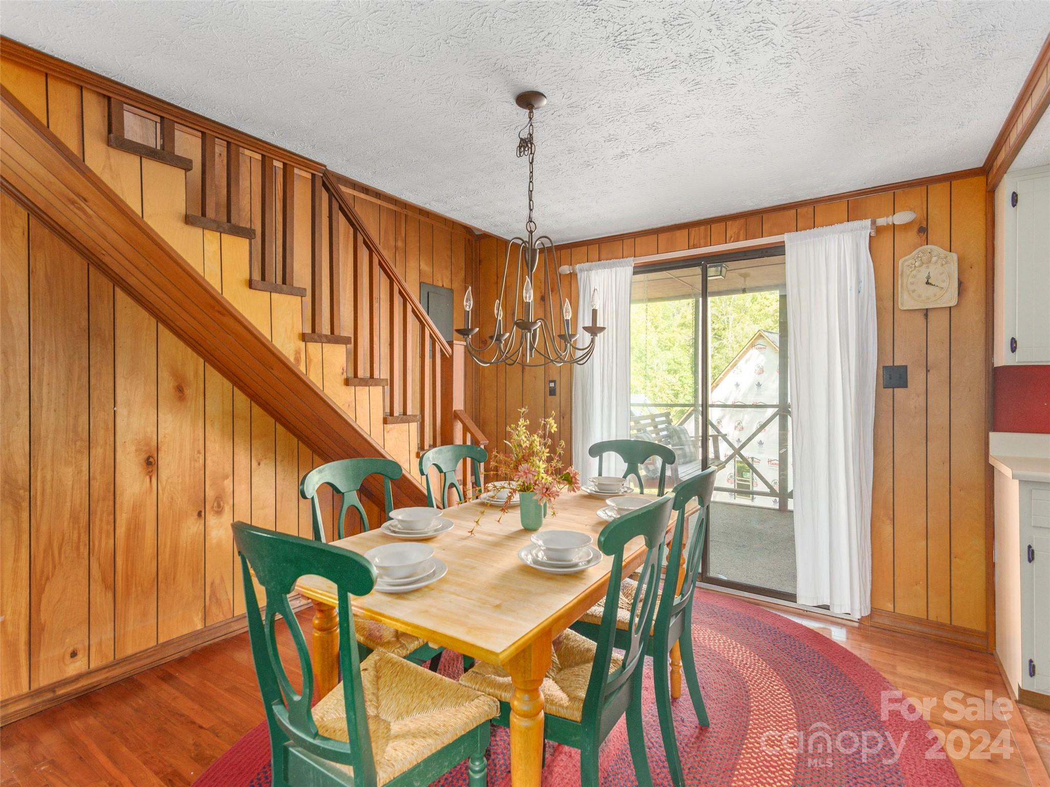 183 Reuben Branch Road Maggie Valley, NC 28751 - Photo 8 of 29 a view of a dining room with furniture window and wooden floor