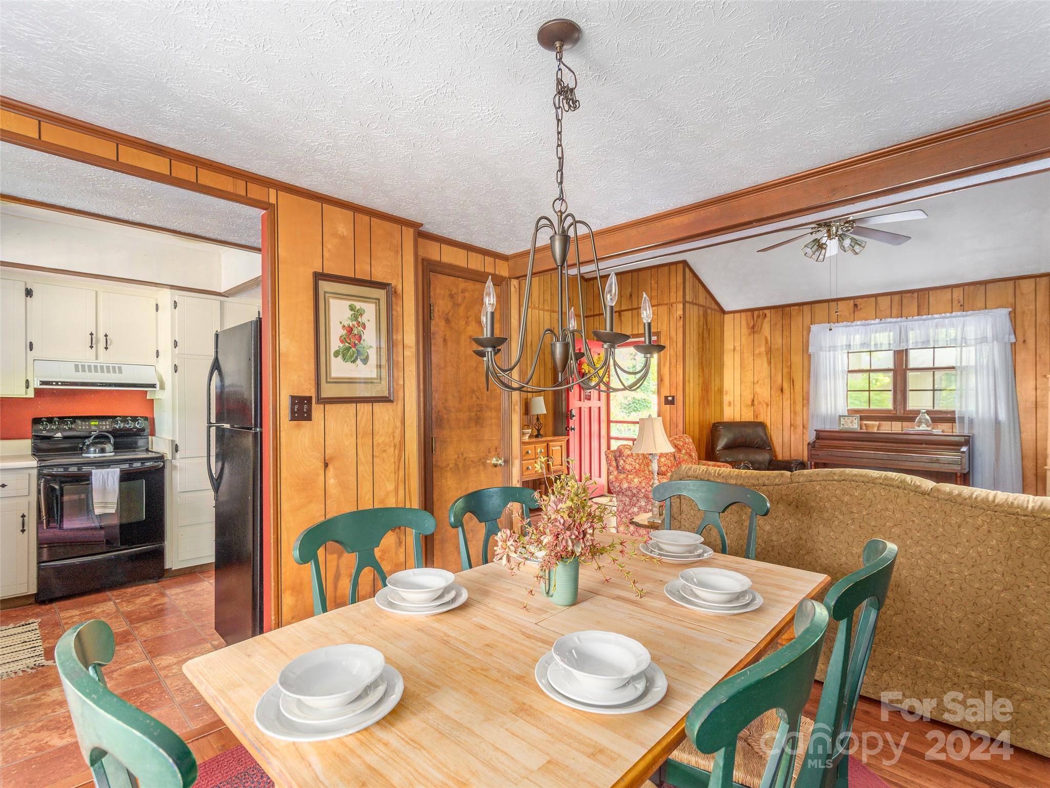 183 Reuben Branch Road Maggie Valley, NC 28751 - Photo 9 of 29 a view of a dining room with furniture window and wooden floor