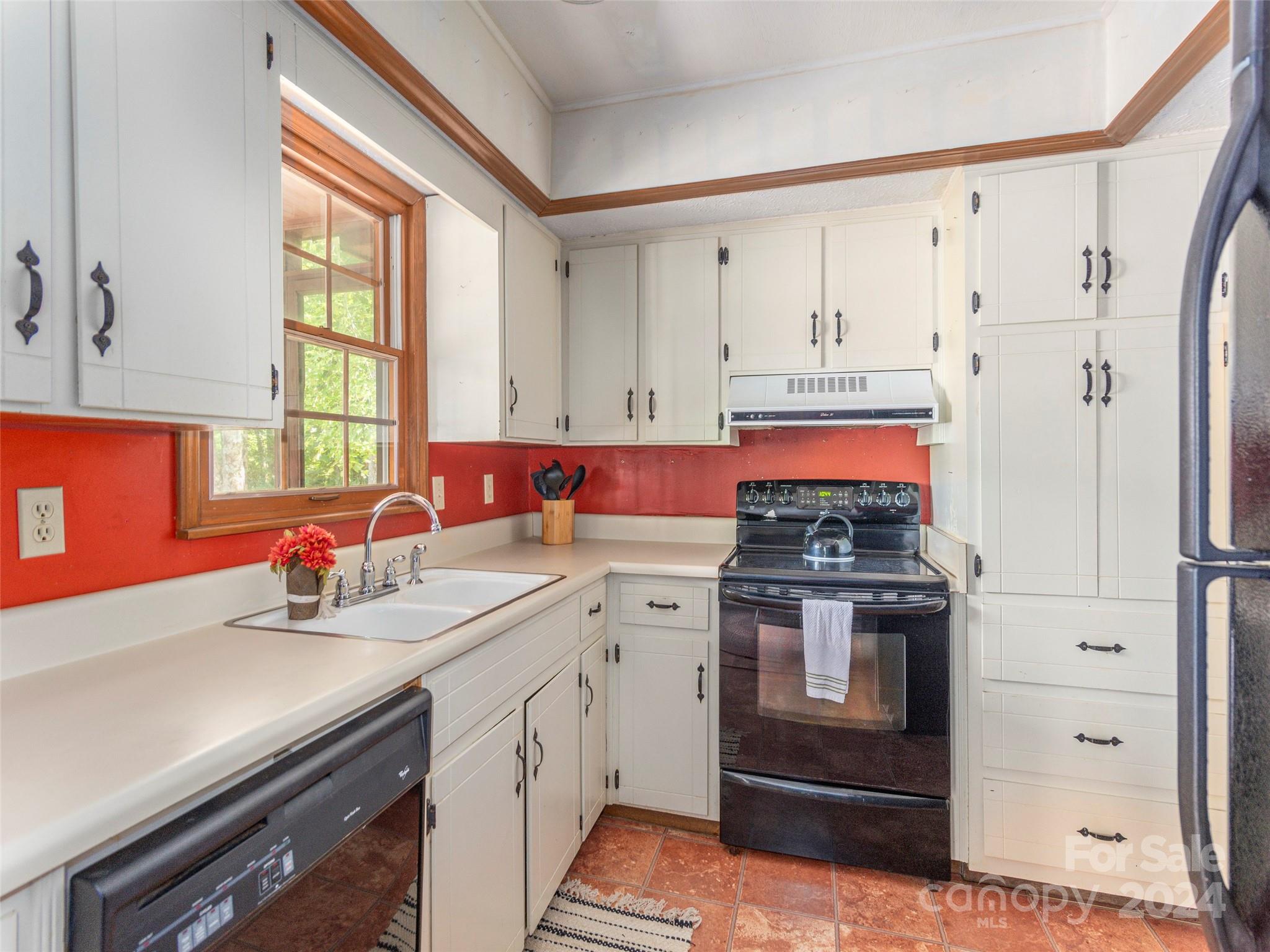183 Reuben Branch Road Maggie Valley, NC 28751 - Photo 10 of 29 a kitchen with stainless steel appliances a stove sink and cabinets