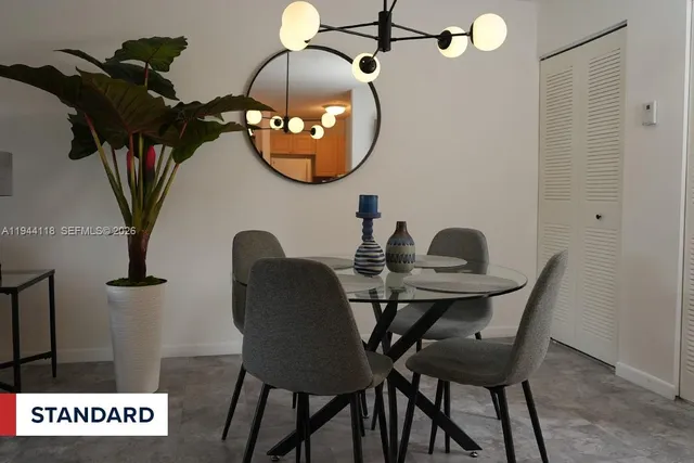 a view of a dining room with furniture and chandelier