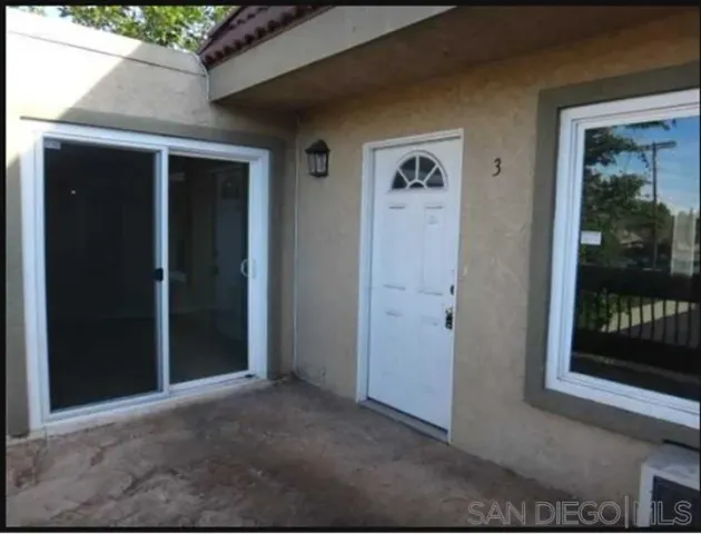 a kitchen with a refrigerator and a stove top oven