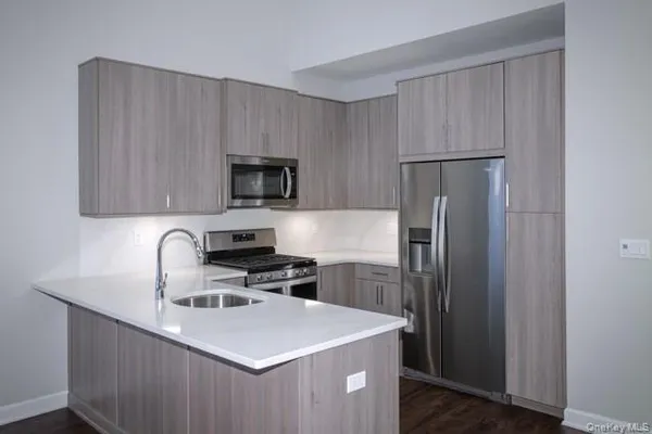 a kitchen with kitchen island a sink stove and refrigerator