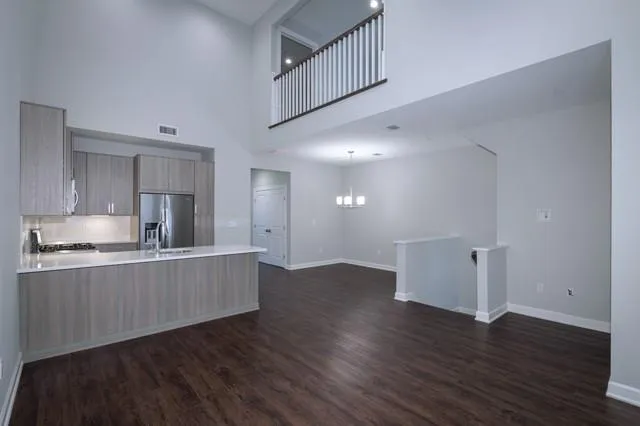 a kitchen with stainless steel appliances granite countertop a wooden floors