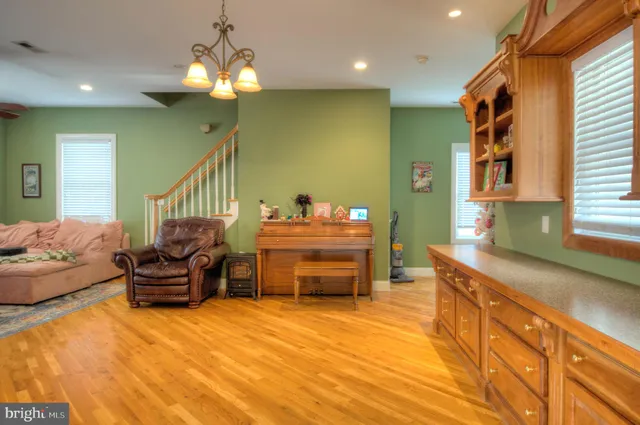 a bedroom with furniture and a wooden floor
