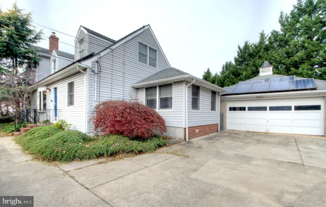 a front view of house with yard and trees around