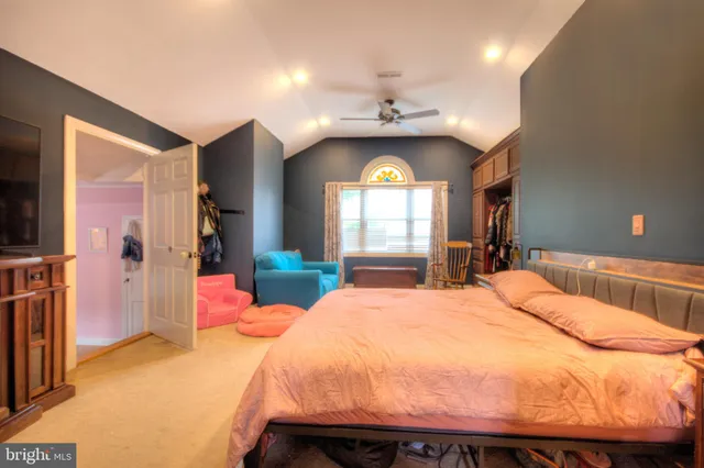 a bedroom with a bed and a chair