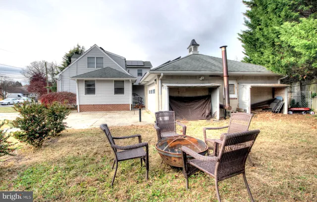 a backyard of a house with yard barbeque oven and outdoor seating