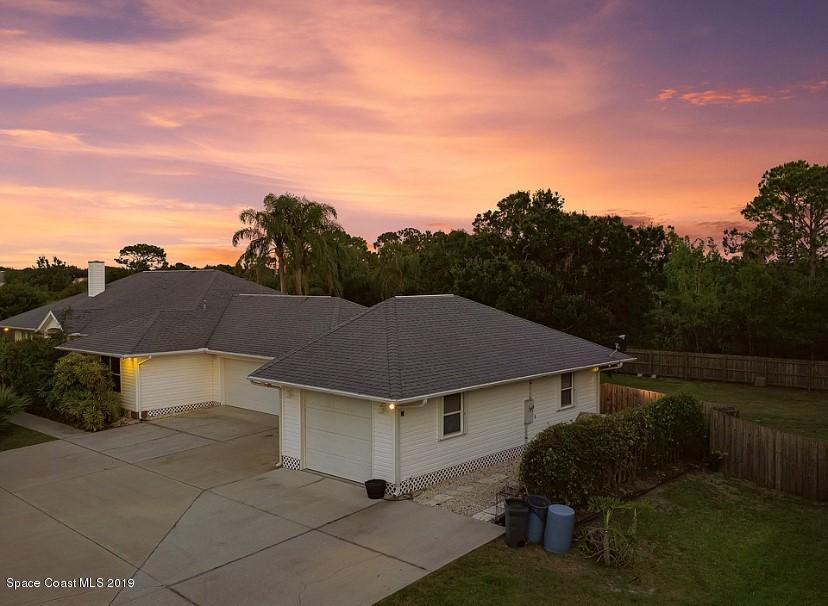 4231 Turtle Mound Road Melbourne, FL 32934 - Photo 2 of 39 a house with trees in the background