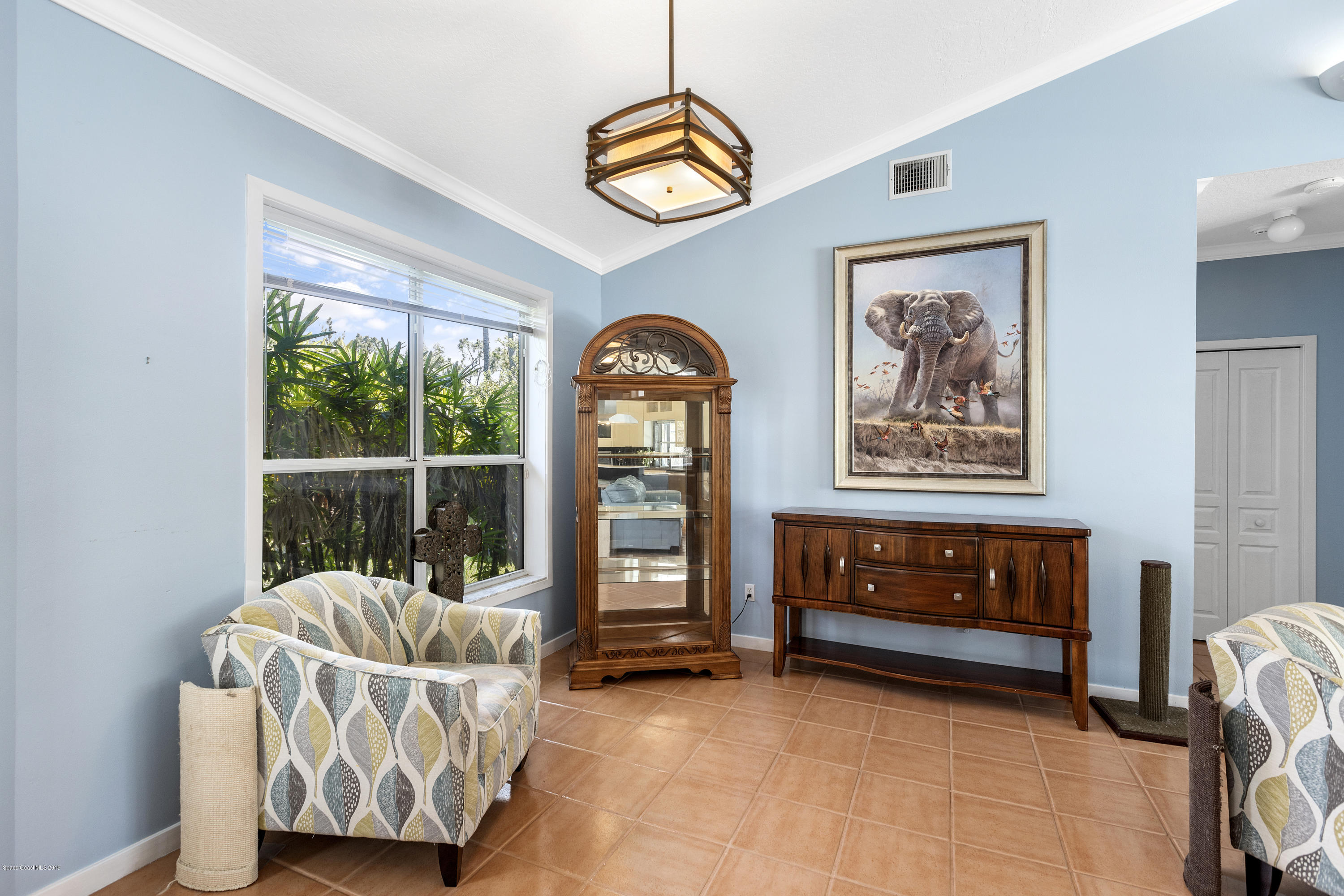 4231 Turtle Mound Road Melbourne, FL 32934 - Photo 11 of 39 a living room with furniture and a window