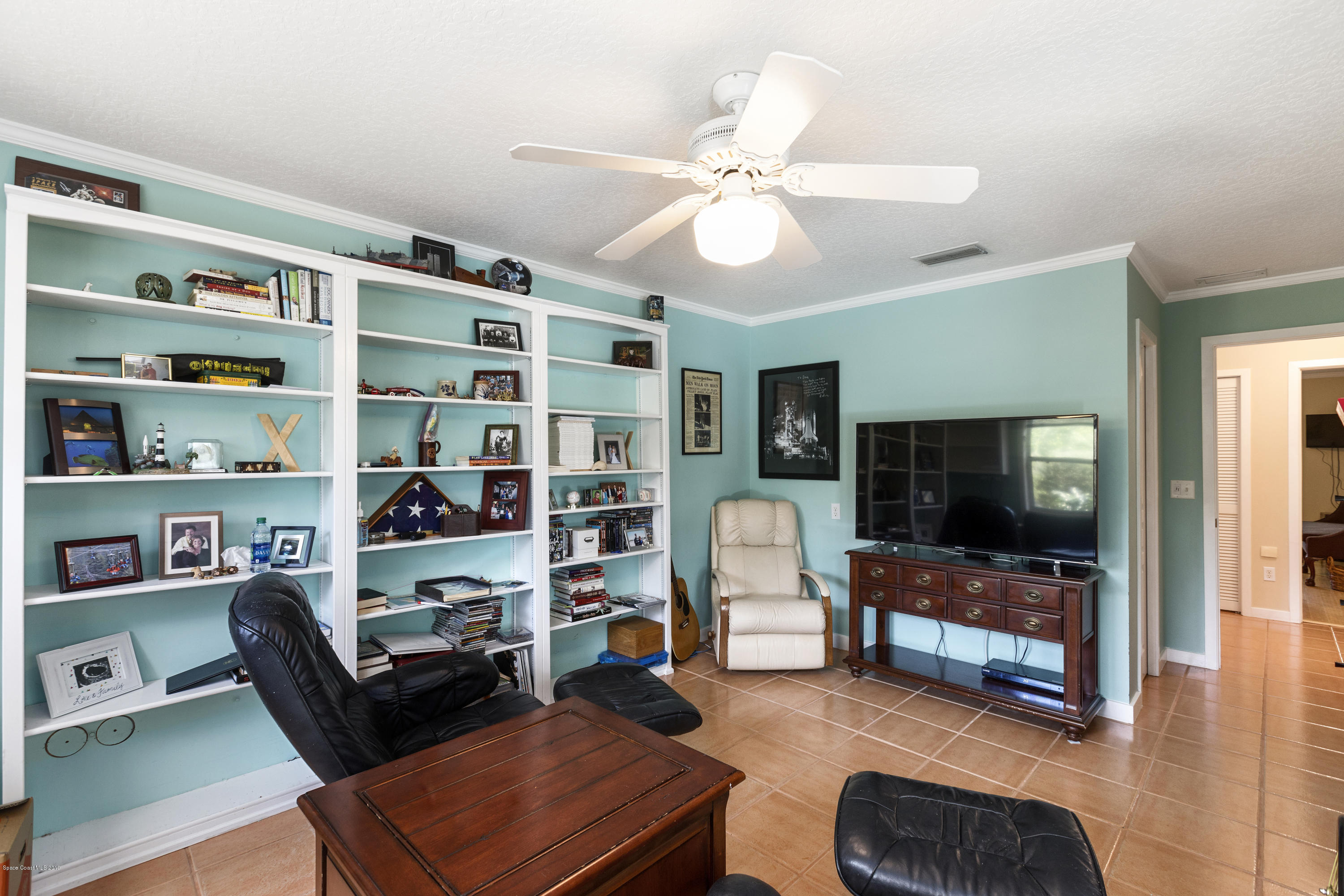 4231 Turtle Mound Road Melbourne, FL 32934 - Photo 15 of 39 a living room with furniture and a flat screen tv