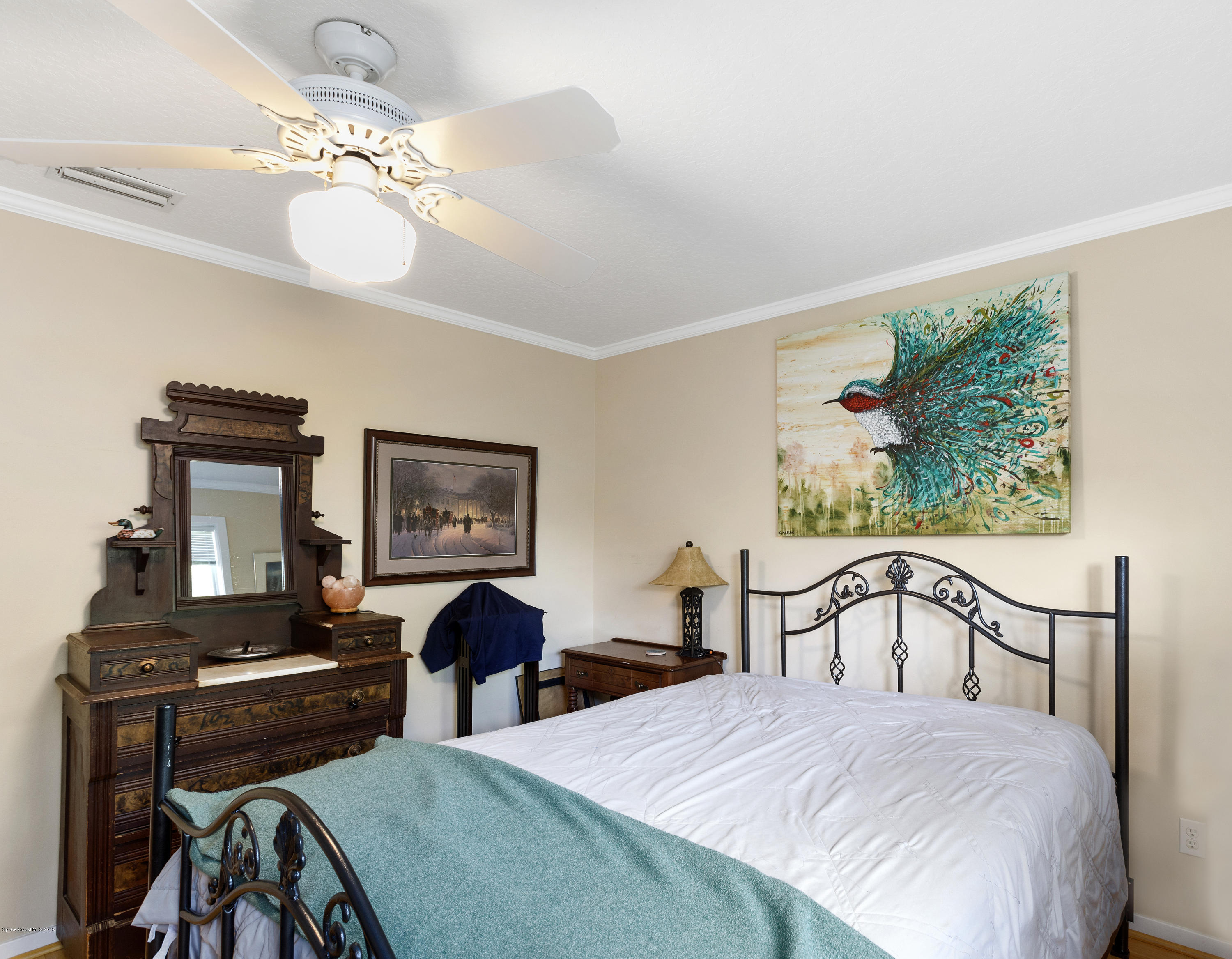 4231 Turtle Mound Road Melbourne, FL 32934 - Photo 19 of 39 a bedroom with double bed windows and a potted plant