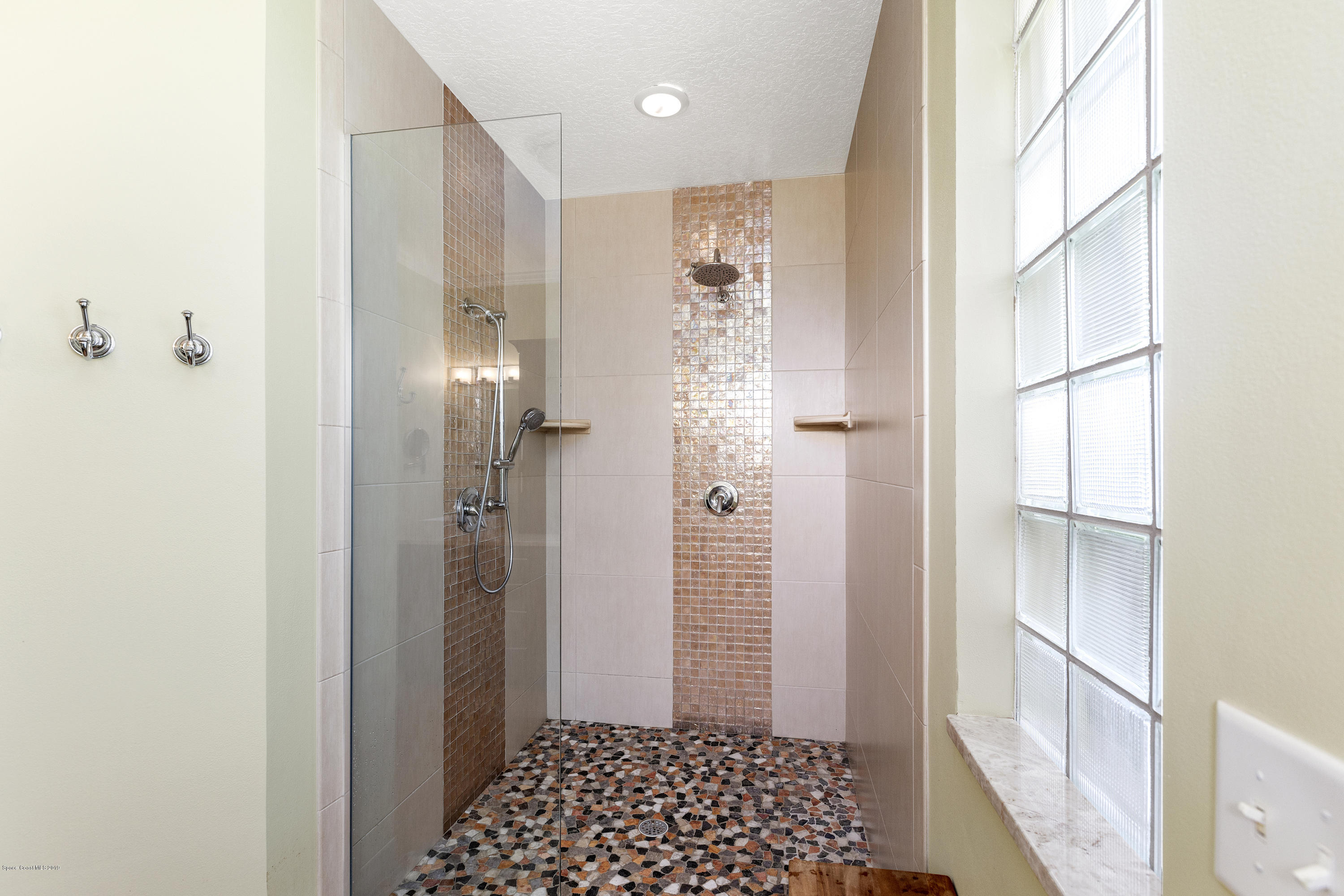4231 Turtle Mound Road Melbourne, FL 32934 - Photo 22 of 39 a bathroom with a shower and a toilet