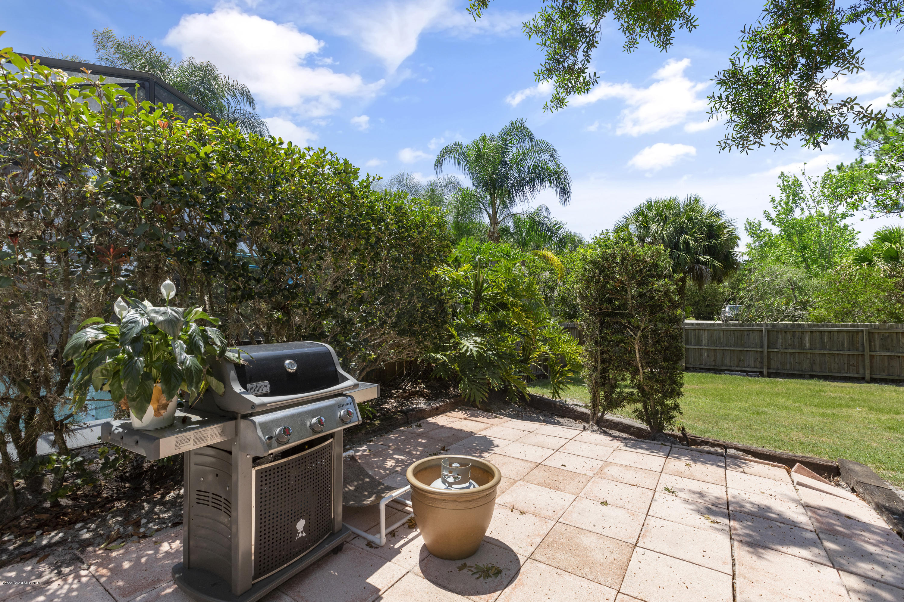4231 Turtle Mound Road Melbourne, FL 32934 - Photo 33 of 39 a view of a backyard with chair and potted plants