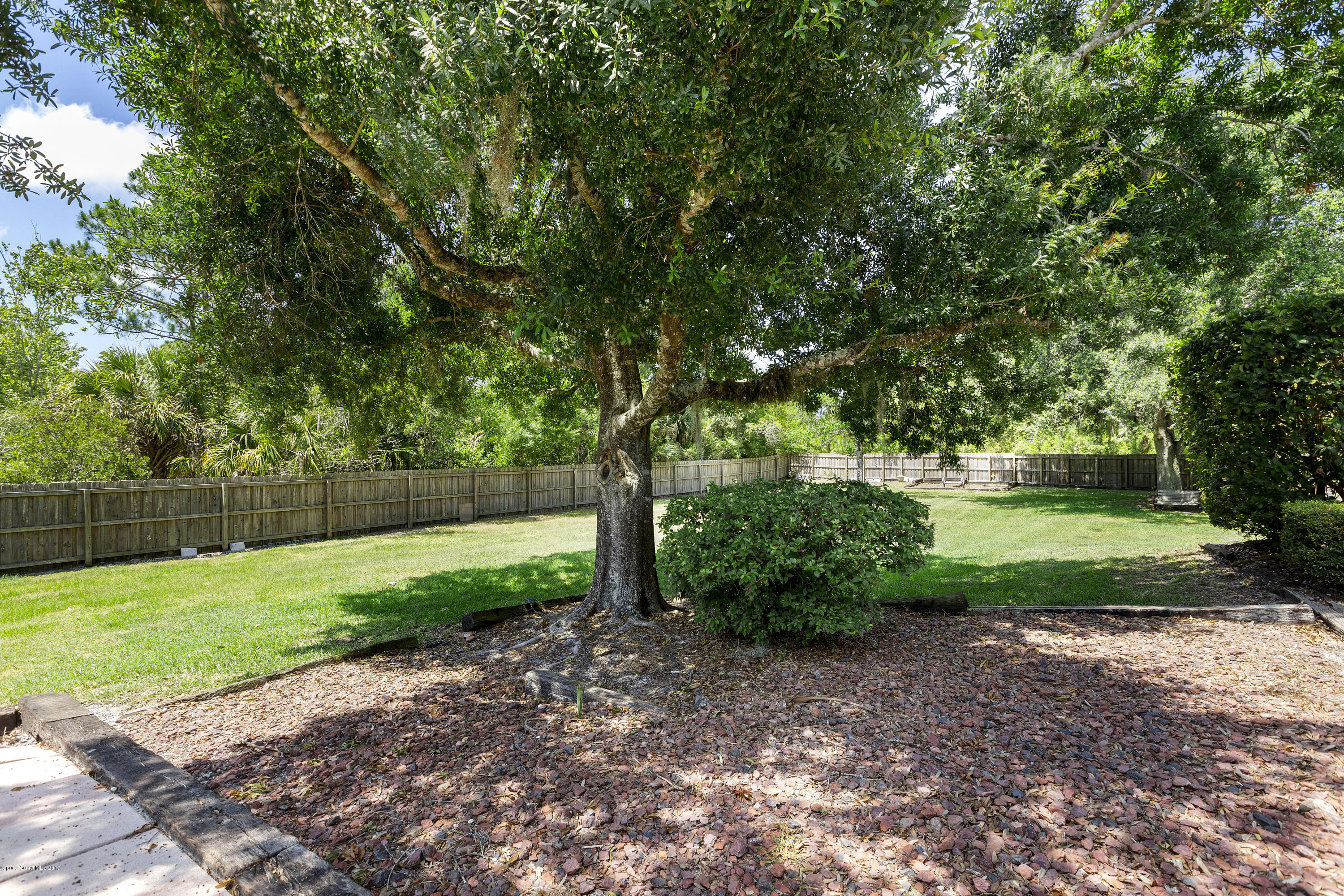 4231 Turtle Mound Road Melbourne, FL 32934 - Photo 34 of 39 a view of a backyard with large trees