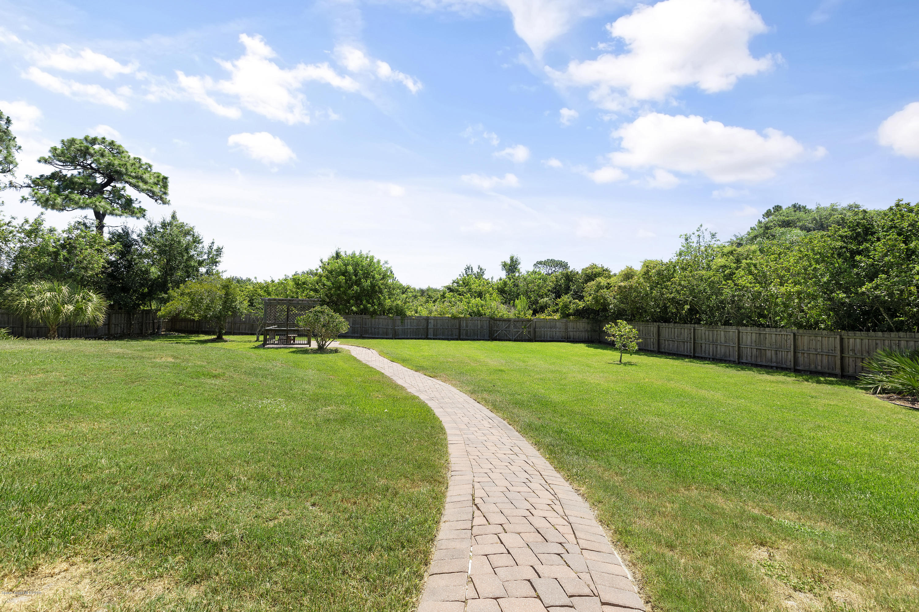 4231 Turtle Mound Road Melbourne, FL 32934 - Photo 35 of 39 a view of a golf course with a garden