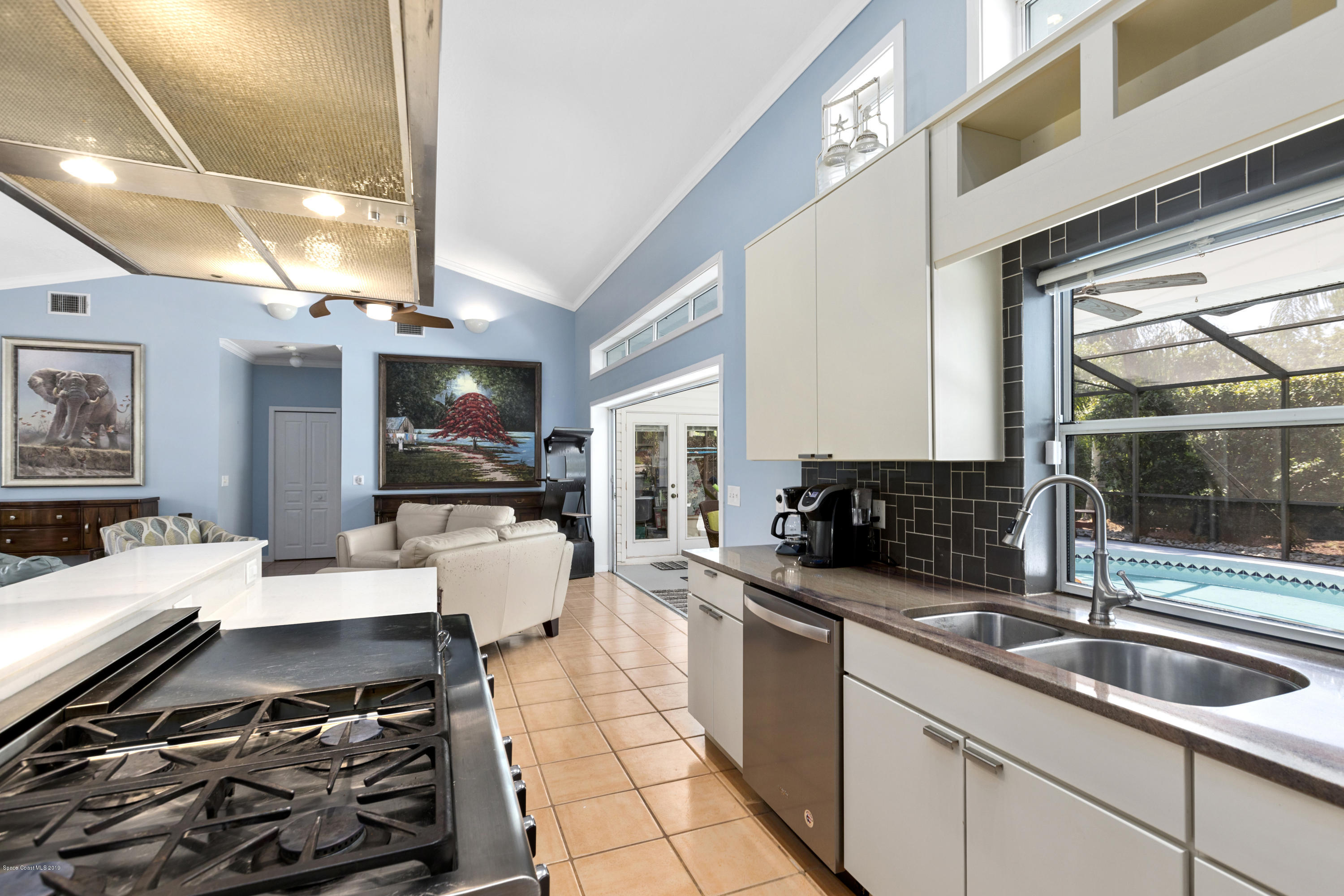 4231 Turtle Mound Road Melbourne, FL 32934 - Photo 9 of 39 a kitchen with stainless steel appliances a stove a sink and a microwave