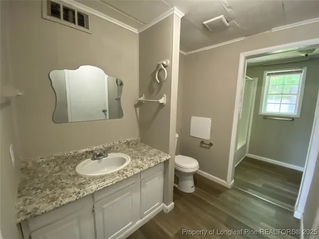 a bathroom with a granite countertop sink toilet and shower