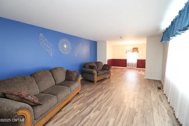 a spacious bathroom with a double vanity sink toilet and a mirror
