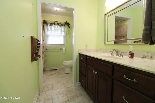 a kitchen with stainless steel appliances granite countertop a sink a stove and a refrigerator with wooden floor