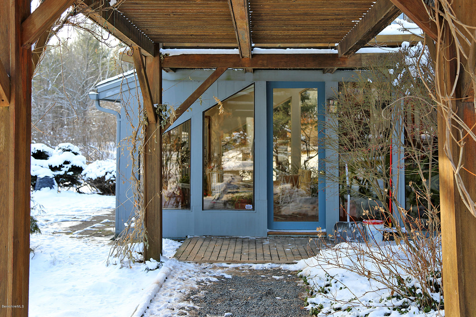 12 Red Rock Road West Stockbridge, MA 01266 - Photo 20 of 31 a view of a porch with a table and chairs and floor to ceiling window