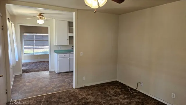 a view of an empty room and bathroom