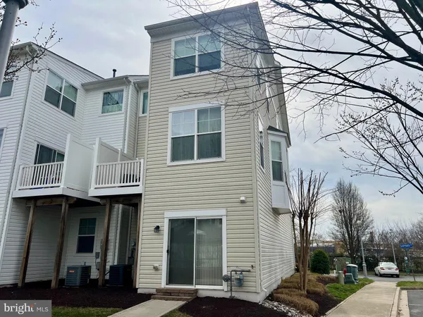 a front view of a building with multiple trees