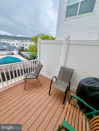 a view of a chairs and table on the wooden deck