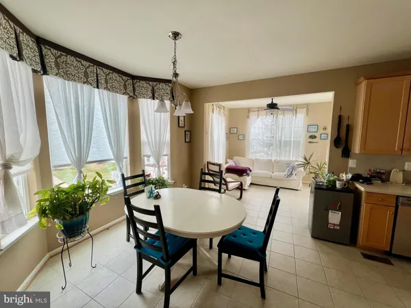 a view of a dining room with furniture and a window