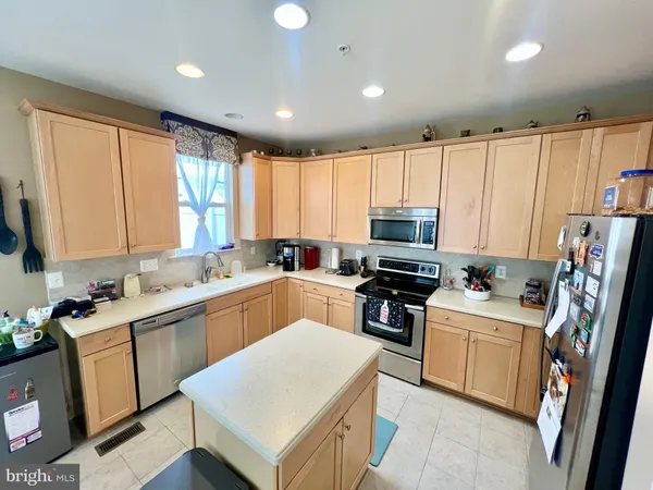 a kitchen with a sink a stove a refrigerator and cabinets